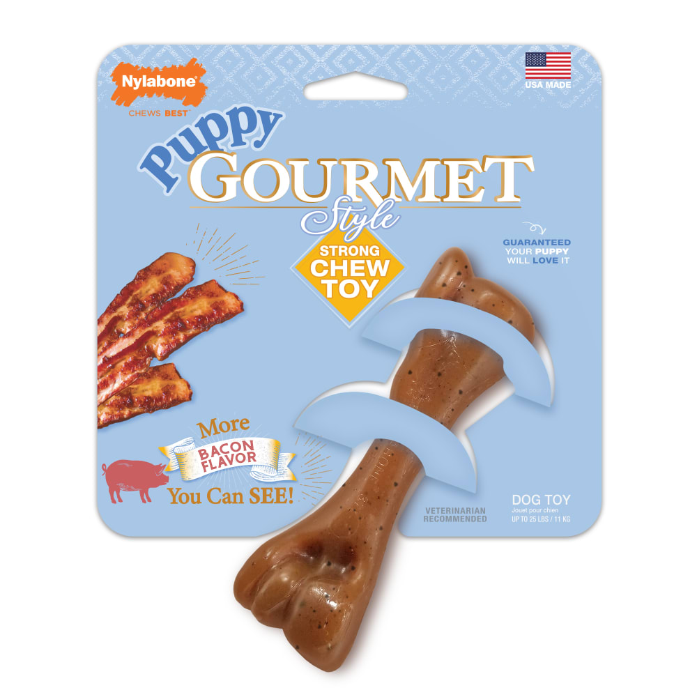 JUGUETE NYLABONE FÉMUR PUPPY GOURMET STYLE, TOCINO